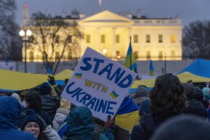 People take part in a vigil to protest the Russian invasion of Ukraine in front of the White House in Washington, Thursday, Feb. 24, 2022.