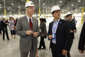 Congressman Bill Foster, left, speaks with Nate Baguio, senior vice president of commercial development for Lion Electric, during a tour of the future bus and truck factory in Joliet.